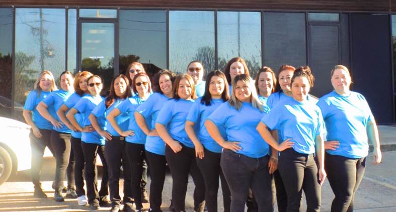A group of women in blue shirts

Description automatically generated